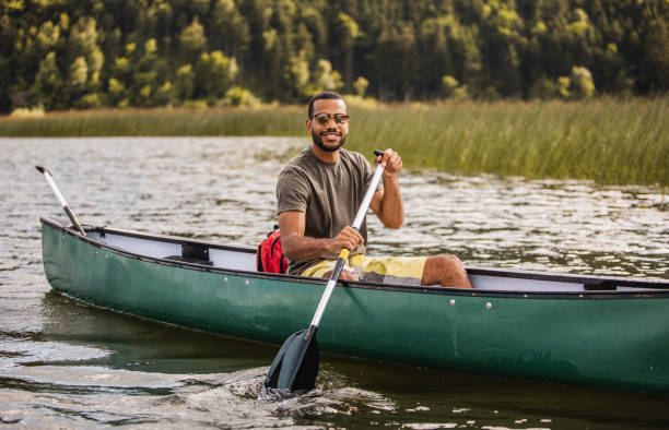 istock Young Man Canoening on the Lake 1152581418