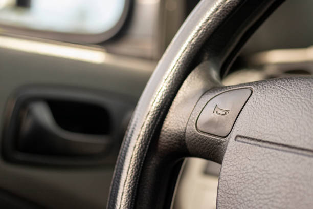 istock driving wheel with horn sign, car interior 1152583034