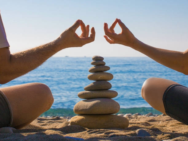 istock Couple practicing yoga on the beach. Zen. Calm and relax. 1152585030