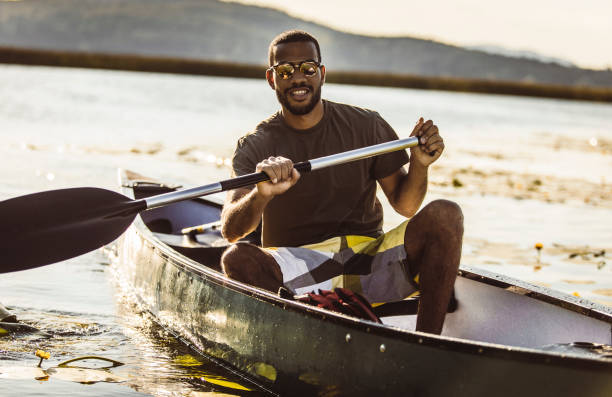 istock Young Man Canoeing on The Lake 1152590916