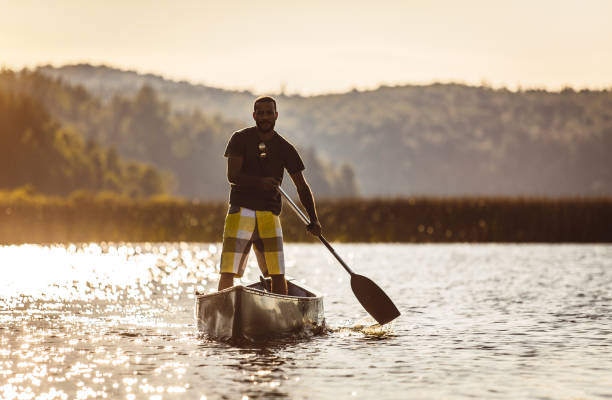 istock Young Man Canoeing on The Lake 1152591603