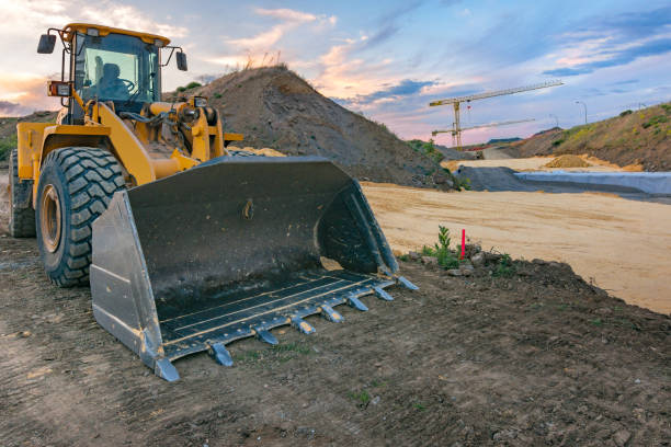 istock Excavator in a construction site with a crane in the background 1152593161