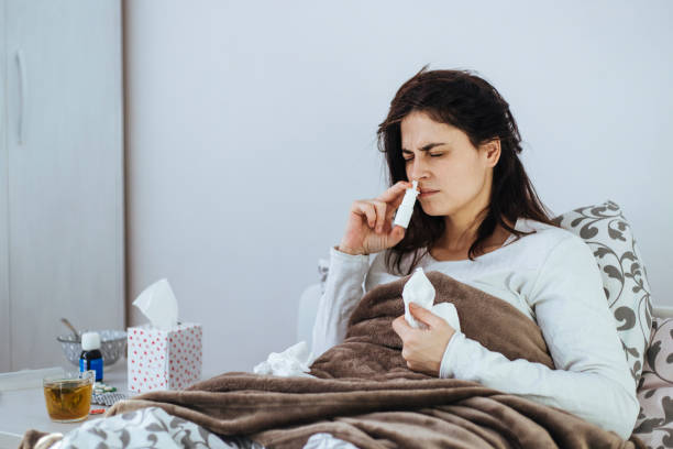 istock Woman Suffering From Cold Lying In Bed With Tissue 1152594471