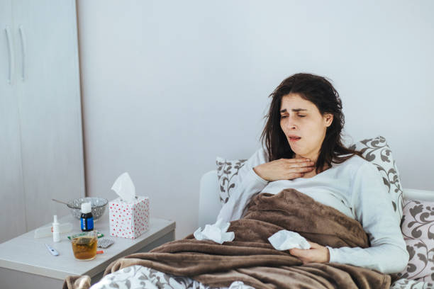 istock Woman Suffering From Cold Lying In Bed With Tissue 1152595073