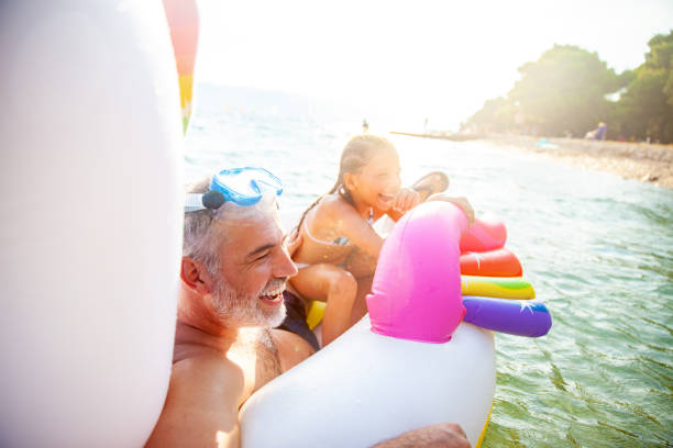 istock Father and Daughter Having Fun With Inflatable Raft on Summer Vacations 1152595183