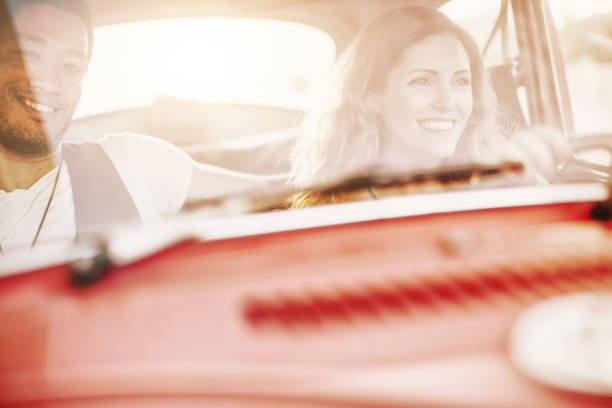 istock Diversity: multiethnic stylish couple in a vintage car 1152596385