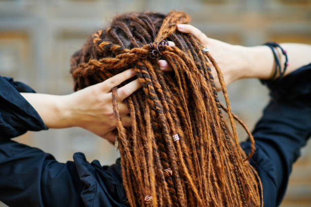 backside dreadlocks head closeup, fashionable girl posing at old wooden door background backside dreadlocks head closeup, fashionable girl posing at old wooden door background dreadlocks stock pictures, royalty-free photos & images