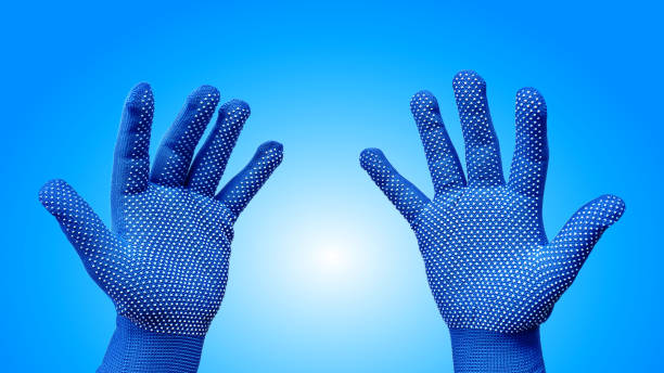 istock Both Hands in Blue Gloves with White Dotted Pattern Isolated on Blue Background 1152597037