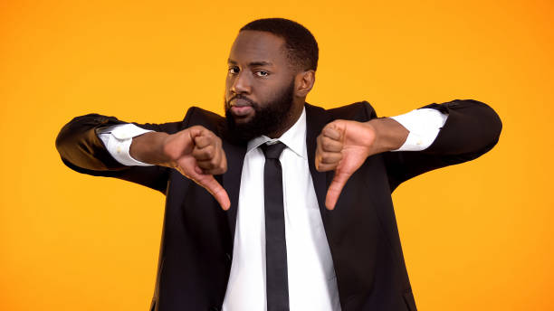 istock Deeply dissatisfied black man showing double thumbs-down, poor quality service 1152597868