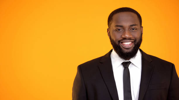 istock Charming afro-american man in formal suit smiling and looking to camera template 1152597907