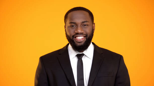 istock Black businessman in suit smiling and looking to camera, sales representative 1152597910