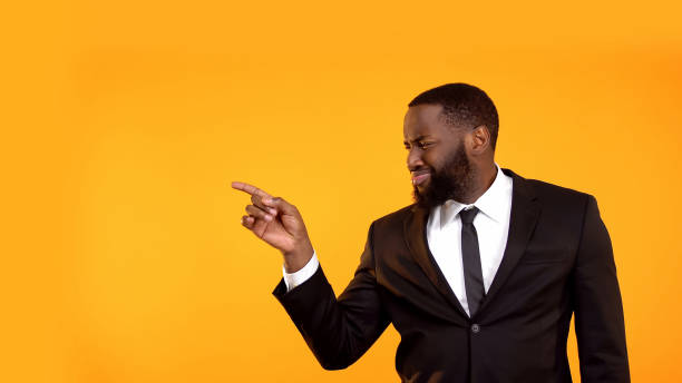 istock African man in formal suit pointing with finger left, advertisement template 1152597964