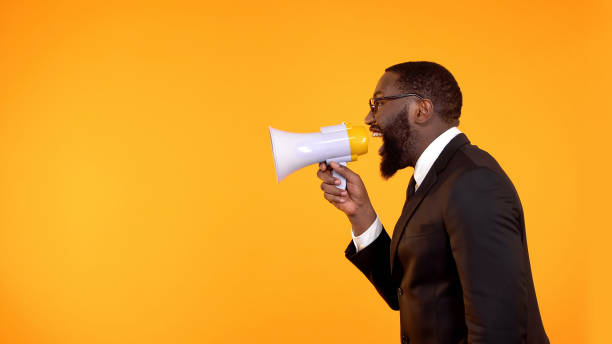 istock Black boss shouting in megaphone, stressful job, project deadline, announcement 1152598089