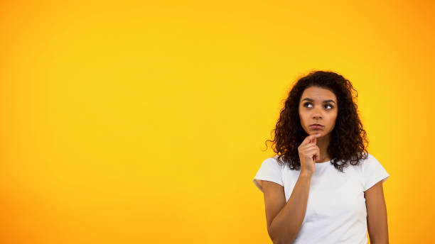 istock Thoughtful black woman touching chin and looking up, choosing between options 1152598265