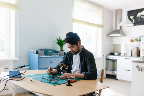 istock Asian vlogger makes smart phone repairing videos 1152598337