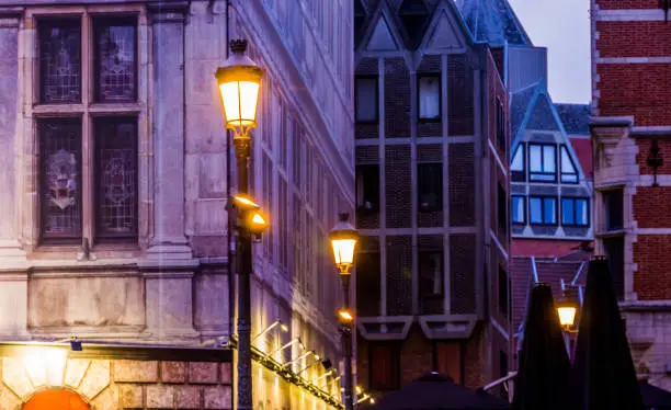 Photo of lighted lampposts with old classical architecture, The city of antwerp by night, Antwerpen, Belgium