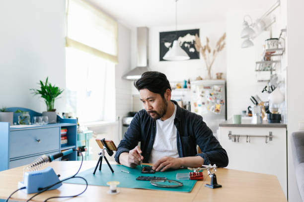 istock Asian man learning from tutorial videos how to repair smart phone 1152598520