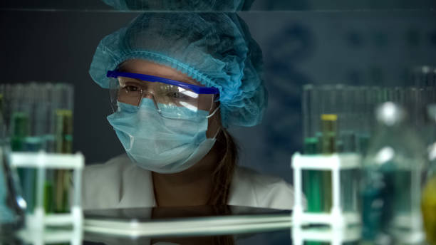 istock Scientist in protective uniform looking at samples in tubes, chemical industry 1152598588