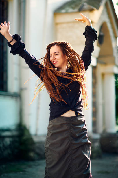 istock dreadlocks fashionable girl having fun and turns head fast 1152598677