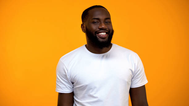 istock Cheerful Afro-American man smiling at camera isolated on yellow background 1152598730