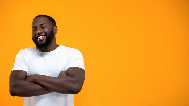 istock Handsome Afro-American man standing with hands crossed, looking at camera 1152599024