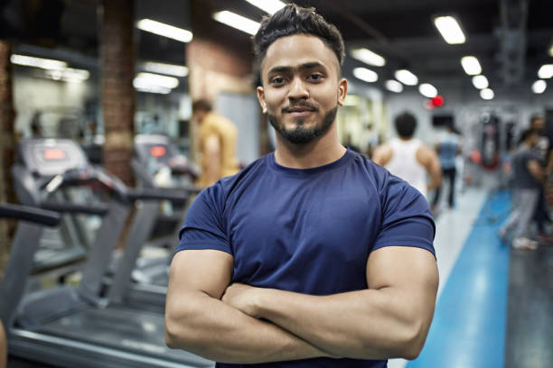 Confident young macho man with arms crossed