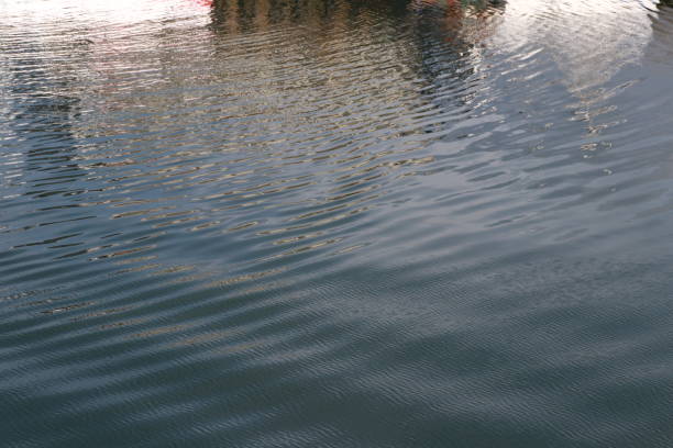 istock Fishing boats reflected in water 1152601263
