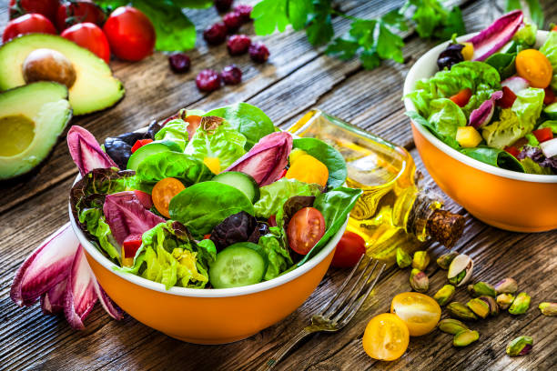 istock Healthy eating: two fresh salad bowls ready to eat on wooden table 1152601352