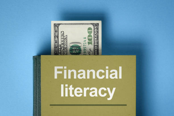 Financial literacy concept The concept of financial literacy. A book with knowledge about money and investments. Bookmark from the dollar bill financial literacy stock pictures, royalty-free photos & images