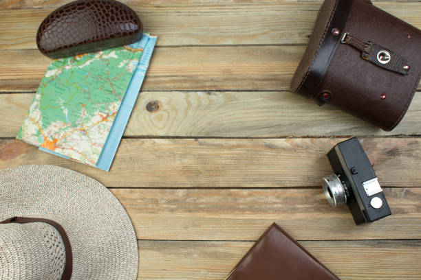 Travel accessories costumes. Passports, luggage, The cost of travel maps prepared for the trip. Top view image of travel accessories with washed out vintage filter effect. stock photo