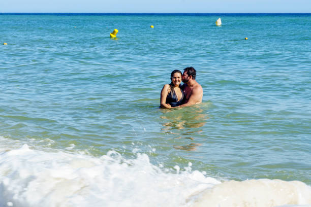 istock Brazilian couple in sea on the Algrave 1152601808