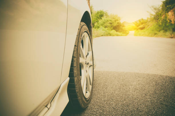 istock car tire with road way to adventure 1152601927