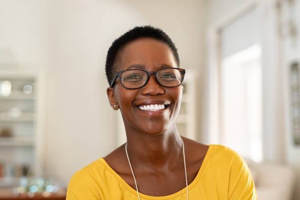 Young woman wearing spectacles Portrait of young woman at home wearing spectacles. Beautiful mature woman wearing eyeglasses and looking at camera. Cheerful african american lady with glasses and short hair. charming photos stock pictures, royalty-free photos & images