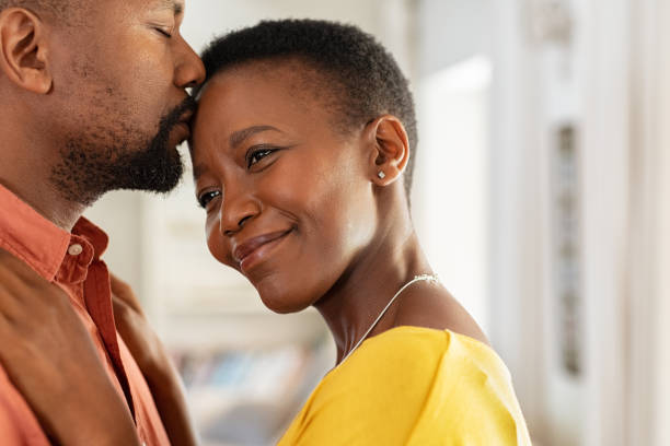 istock Black man kissing his wife on forehead 1152602551