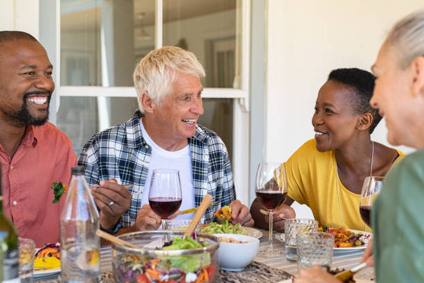 istock Mature friends enjoying lunch together 1152603057