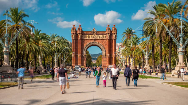 Barcelona, Spain, People at Arc de Triomf on a Sunny Day Barcelona, Spain - October 24, 2018: Tourists and locals at Arc de Triomf on a sunny day in Barcelona, Catalonia, Spain. arc de triomf barcelona stock pictures, royalty-free photos & images