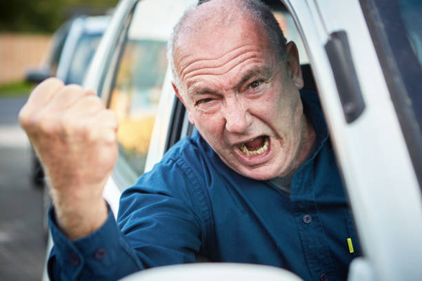 rabia de carretera: conductor masculino de alto nivel furioso sacudiendo puño y gritando - shaking fist fotografías e imágenes de stock