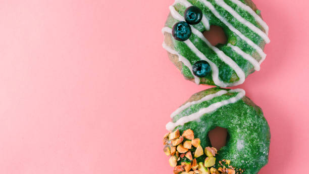 istock Donut topped matcha tea glaze on pink 1152608717