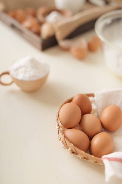 istock Young man's hands whisk eggs with sugar to bake fruit cake. Male cooking dough for pie on white table 1152608755