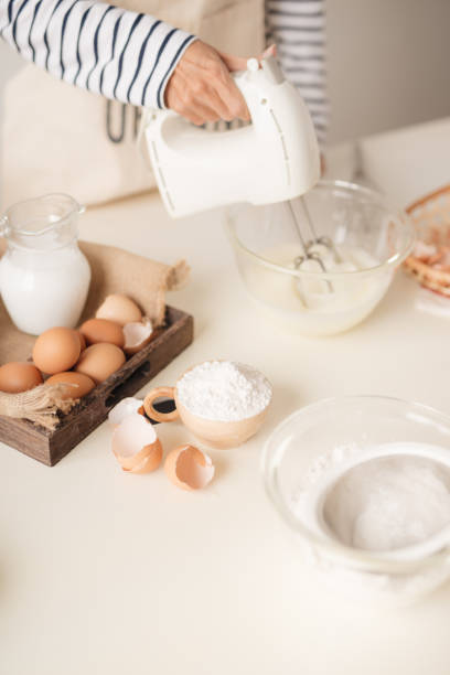istock Male hands beating egg whites cream with mixer in the bowl 1152609321