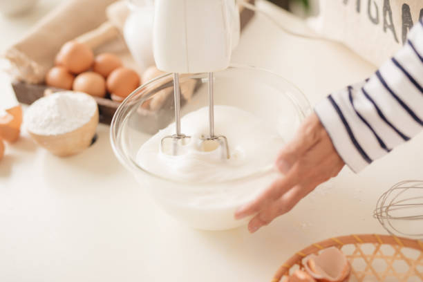 istock Mixing white egg cream in bowl with motor mixer, baking cake 1152609444
