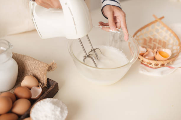 istock Male hands beating egg whites cream with mixer in the bowl 1152609452