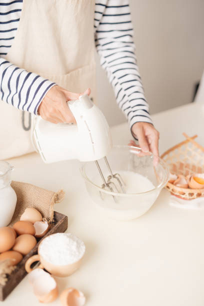 istock Male hands beating egg whites cream with mixer in the bowl 1152609793