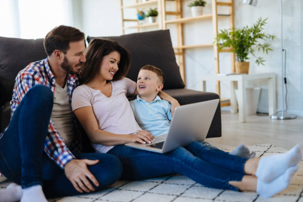 istock Happy family with little boy enjoying using laptop together 1152609949