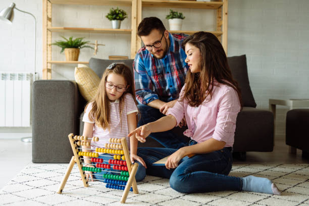 istock Little girl and her parents learning mathematics at home using abacus 1152612327