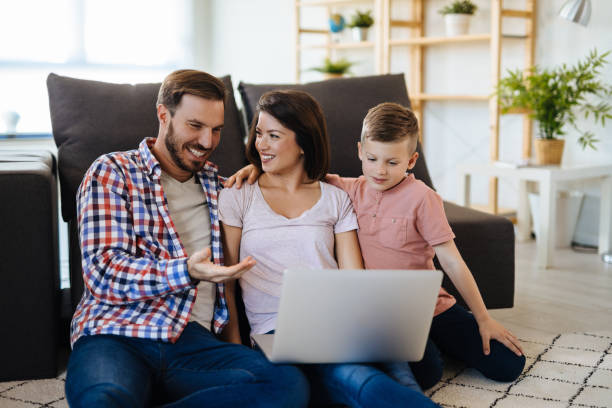 istock Happy family with little boy enjoying using laptop together 1152612367