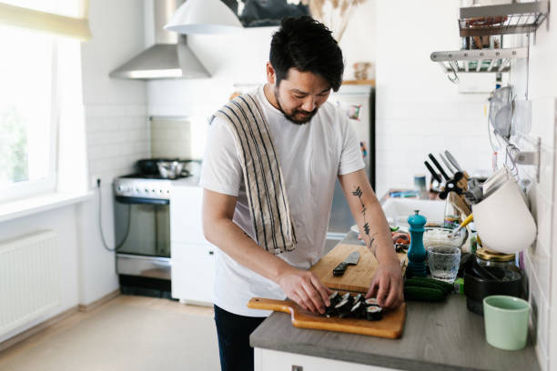 istock Japanese man serving sushi on a cutting board 1152612764