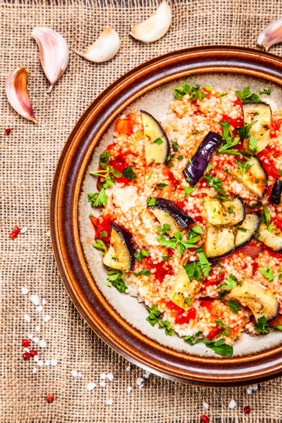 istock Couscous and vegetables on wooden table 1152614614