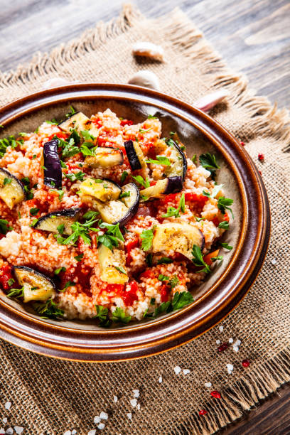istock Couscous and vegetables on wooden table 1152614784