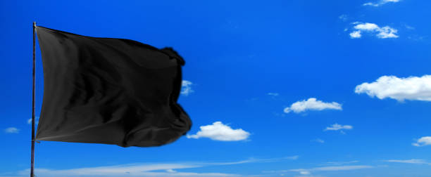 istock waving blank black flag over sunny blue sky 1152614805
